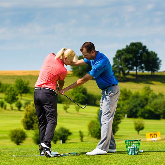 Pro golfer training a woman