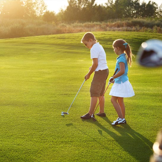 Young kids playing golf